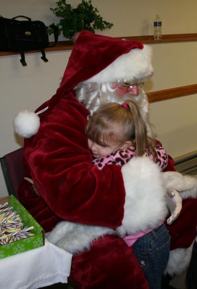 Santa hugging a little girl