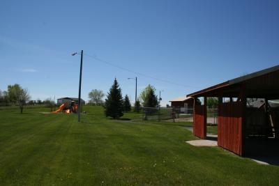 Grassy field with childrens' play equipment
